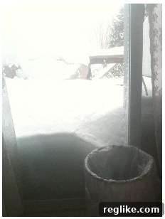 Berryhill's Snow-Covered Deck Deep snow covers a deck, almost reaching the waist-high railing, illustrating severe winter weather disruption.