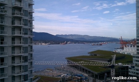 Vancouver Scenic View Panoramic daytime view of Vancouver's harbor and city skyline, with mountains in the background, taken from a high viewpoint.