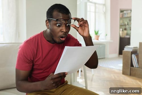 Valuing Virtual Real Estate: Domain Name Economics 2 Man surprised about high bill, symbolizing unexpected domain renewal price hikes