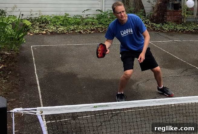 Pickleball Cybersquatting Battle Serves Up a Kitchen Violation 2 Picture of man playing pickleball. He stands ready to swing at ball in the air