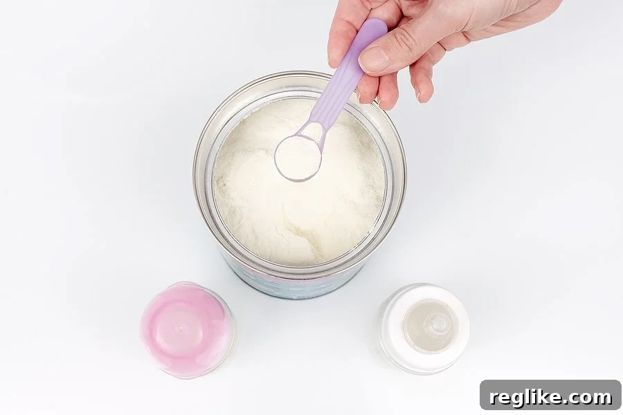 Picture of hand scooping baby formula powder into a bottle
