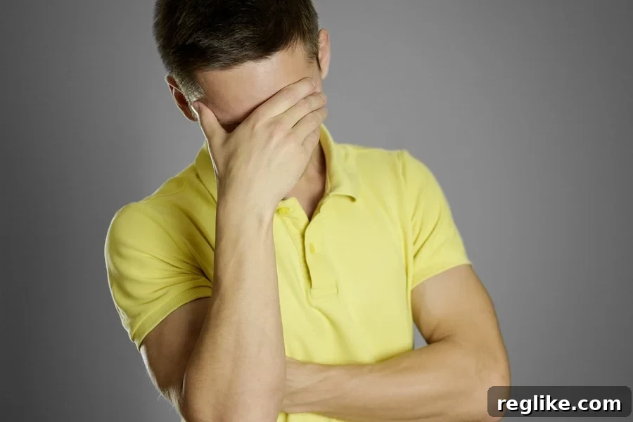 Man covering his face wearing a yellow shirt, representing a terrible argument in a UDRP domain dispute case.