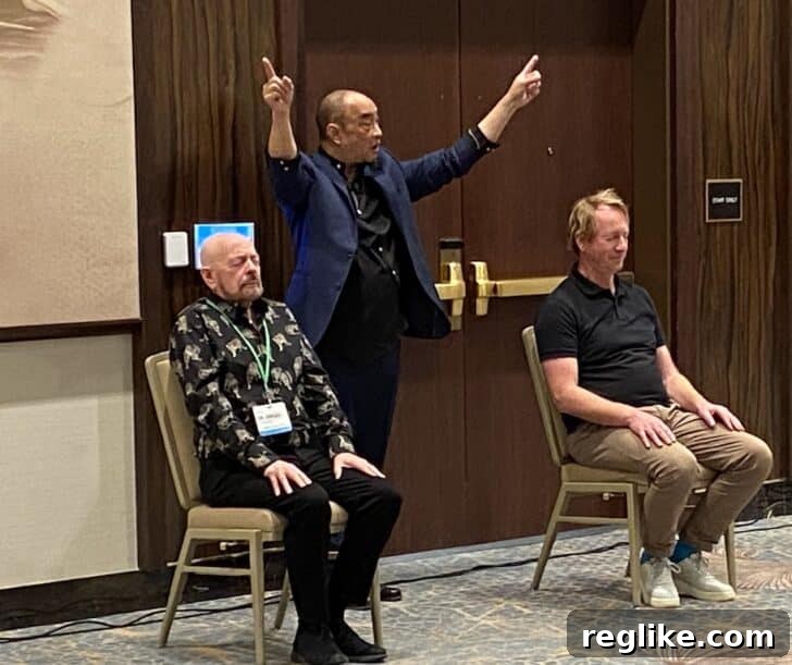 Mentalist Alain Nu performing with Gregg McNair and Christian Voss, entertaining the crowd at an ICA event