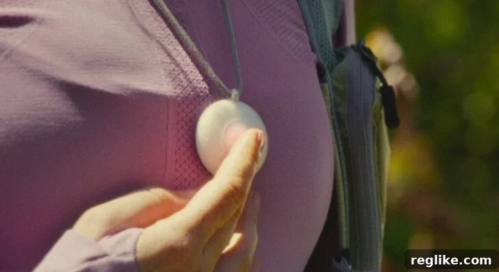 Image of Friend device on a woman's chest, illustrating its wearable nature and direct user interaction.