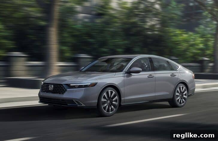 A sleek Honda Accord drives along a busy city street at dusk, symbolizing the brand's enduring presence.