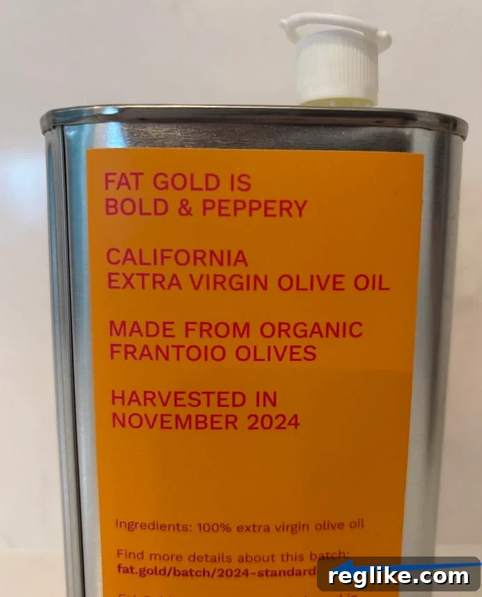 A can of olive oil with fat.gold domain name on it