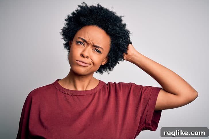 Woman scratching her head in confusion